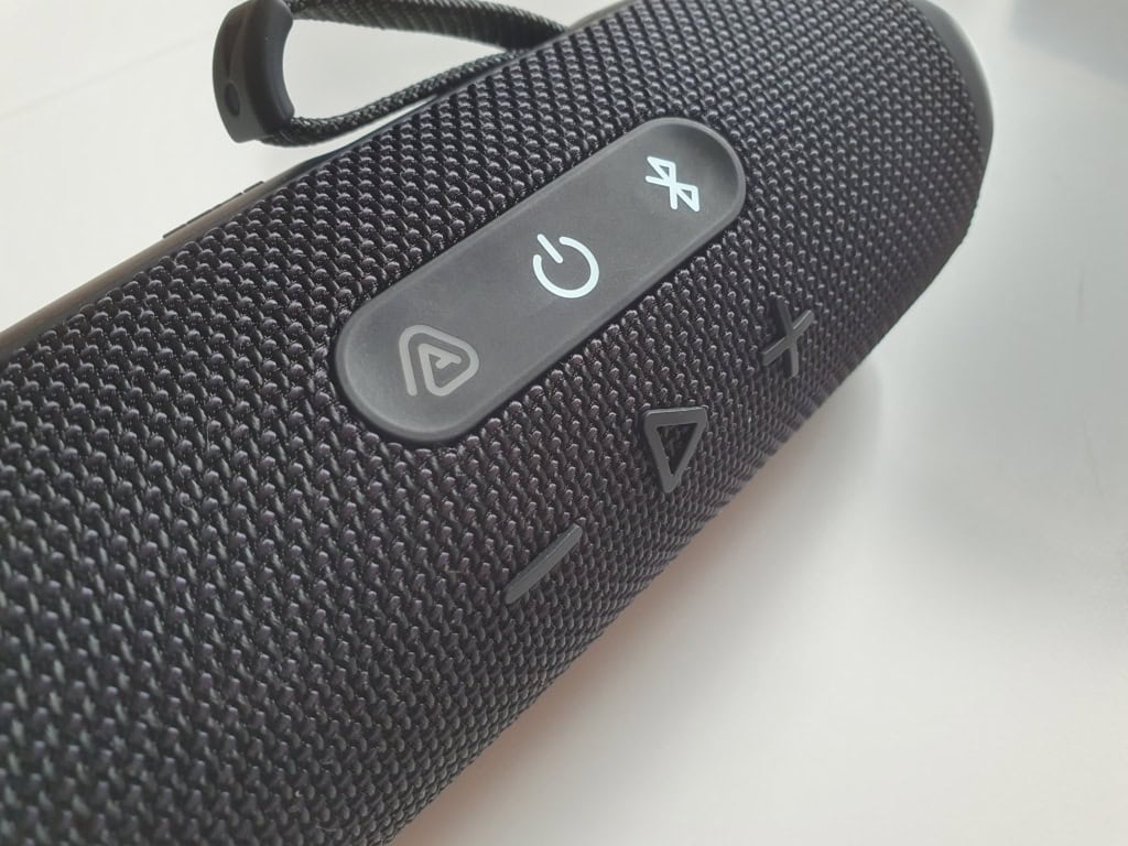 A close up of a black portable speaker.